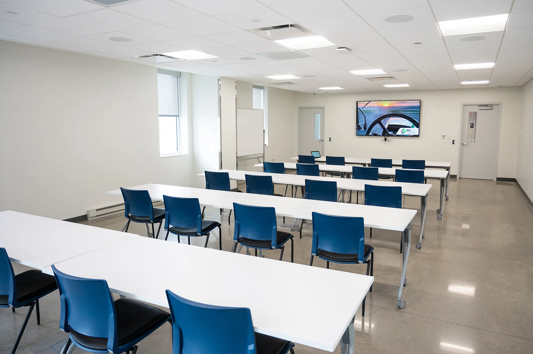 View of the Grand Farm Innovation Shop Classroom - back of room featuring tables and chairs